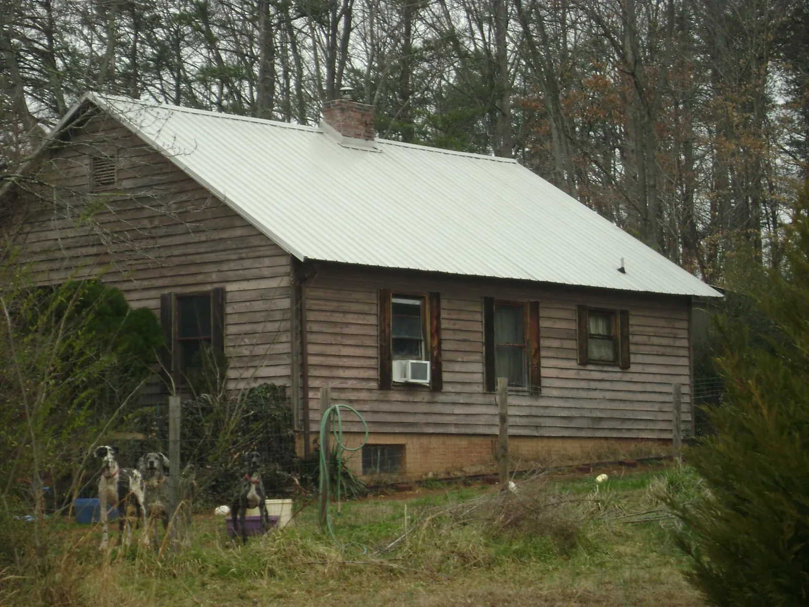 White metal roof on an old wood sided farmhouse, from a Asphalt Shingle Roof Repair job in Penn